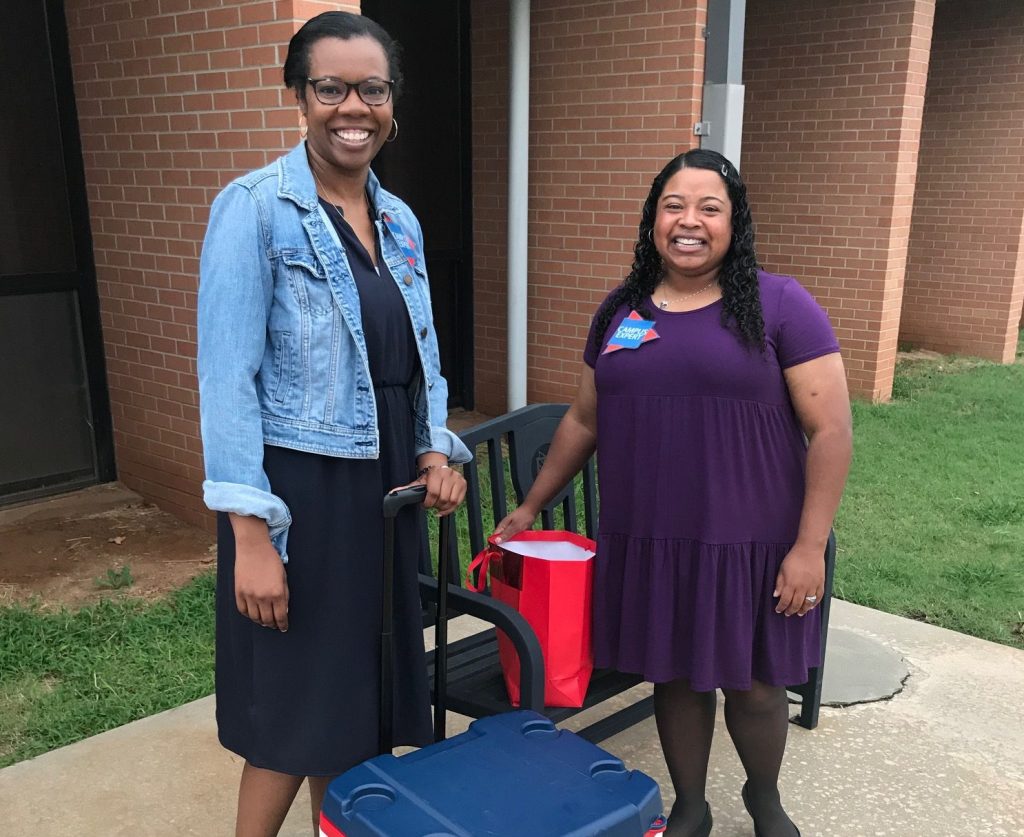 Director of Human Resources Courtney Jones and Language Arts and Humanities Division Chair Christal Knowles prepare to welcome students outside of Tanner Hall.