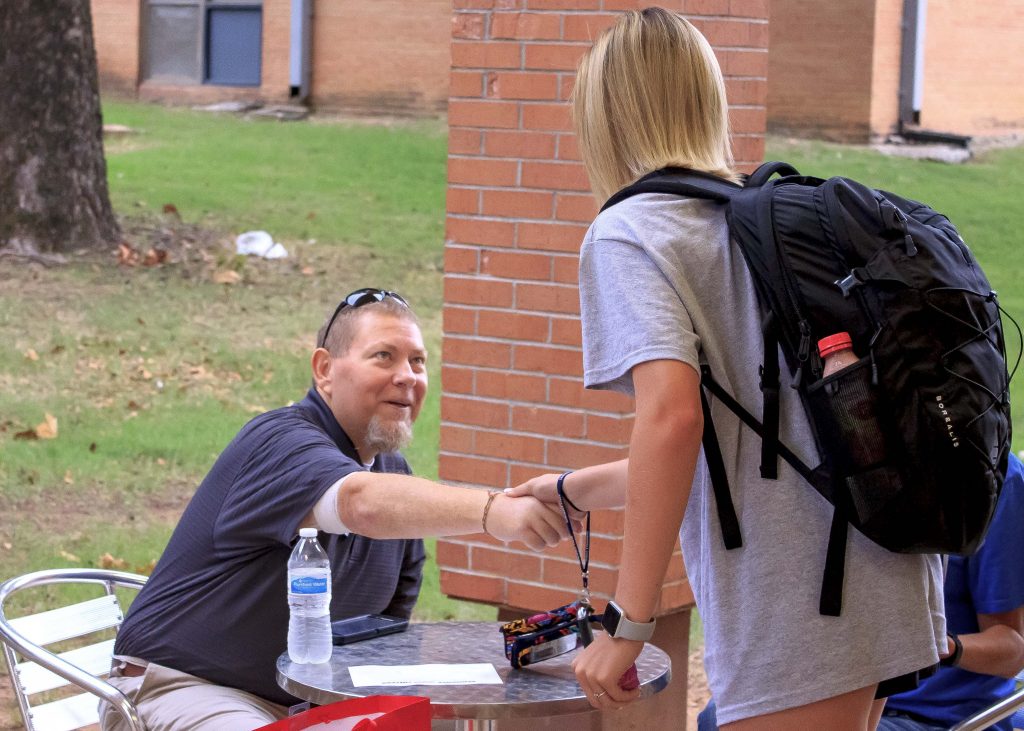 Pictured is SSC Vice President for Student Affairs Dr. Bill Knowles greeting a student outside of the Student Union.