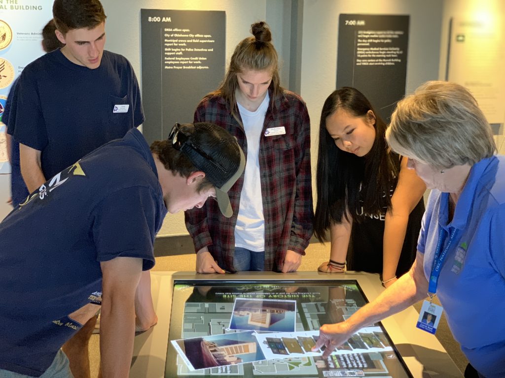 Pictured (from left to right): SSC students Brett Smith of Edmond, Gavin Winchester of Prague, McKenna Hanan of Seminole and Jenny Chen of Tecumseh look as an OKC Bombing Memorial tour guide shows the layout of the Alfred P. Murrah Federal Building.