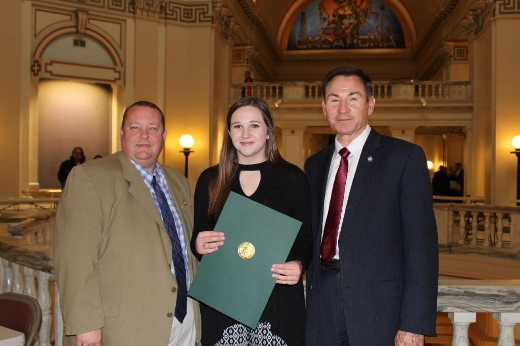 SSC student Alyssa Black (center) is congratulated by Representative Dell Kerbs (left), R-Shawnee, and Senator Ron Sharp (right), R-Shawnee,