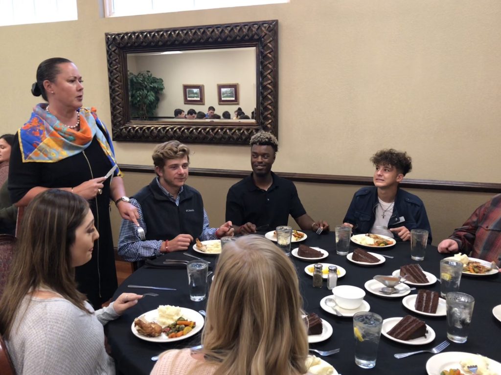 Etiquette expert Carey Sue Vega explains the proper way to cut an entree at a formal dinner to a table of SSC President's Leadership Class students.