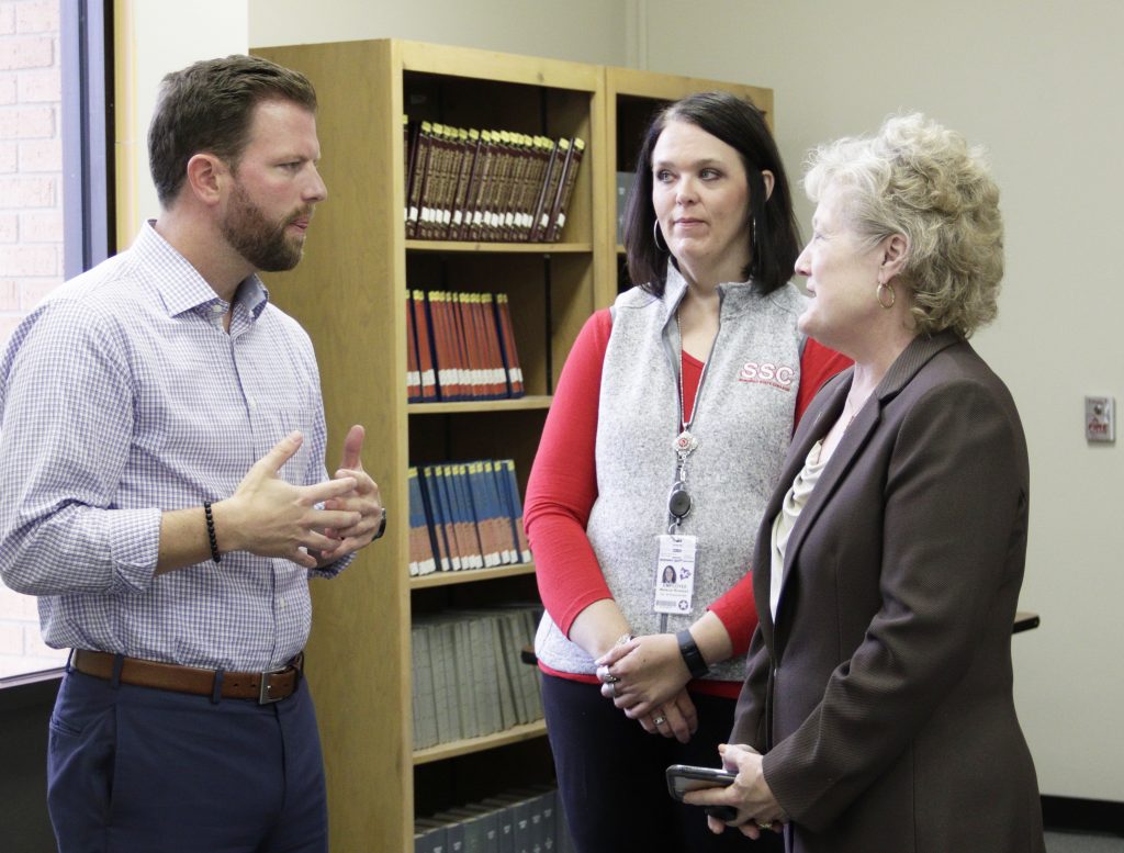 President Lana Reynolds (right) and Financial Assistance Director Melanie Rinehart (center) thanked Representative Jason Dunnington (left).