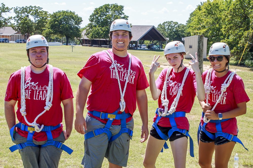 PLC students (l-r) Beau Johnston of Weleetka, Jake Robbins of Ft. Gibson, McKenna Hanan of Seminole and Hope Armstrong of Holdenville stop for a group photo as they prepare to take on the high ropes course at St. Crispin’s.