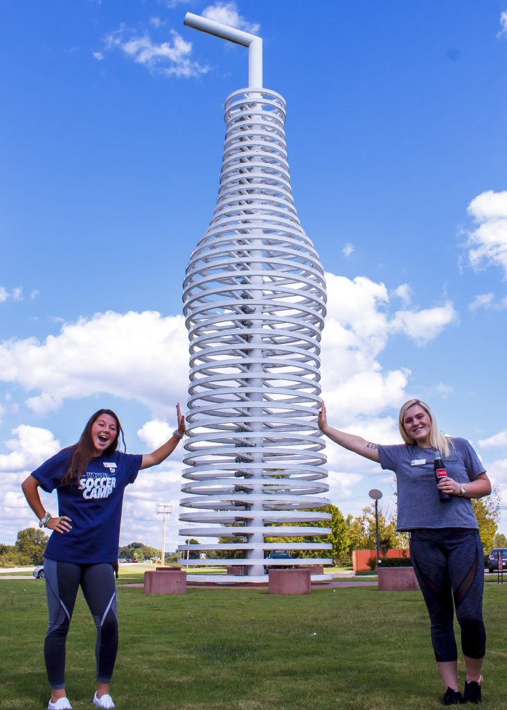 Pictured (left – right): Daryian Fancher, of Harrah, and Triniti House, of Holdenville, pose in front of Pops’ 66-foot soda bottle structure.