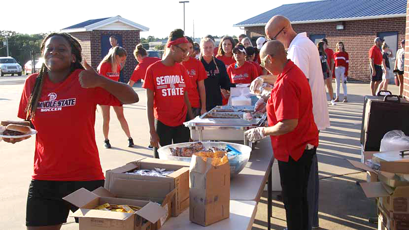 Seminole Coaches Serving Food
