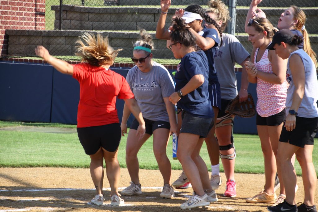 Women running across home plate