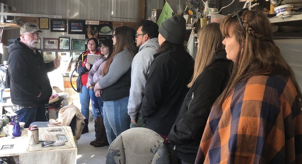 Local artist Paul Pfrehm (left) explains the horse hair raku ceramic firing process to Seminole State College Art Club students (from left to right) Kristen Ivey, Montana Douthit, Cassie Duncan, Antonio Torralba, Nicholas Billie, Kaylen Richardson and Janelle DeFries.