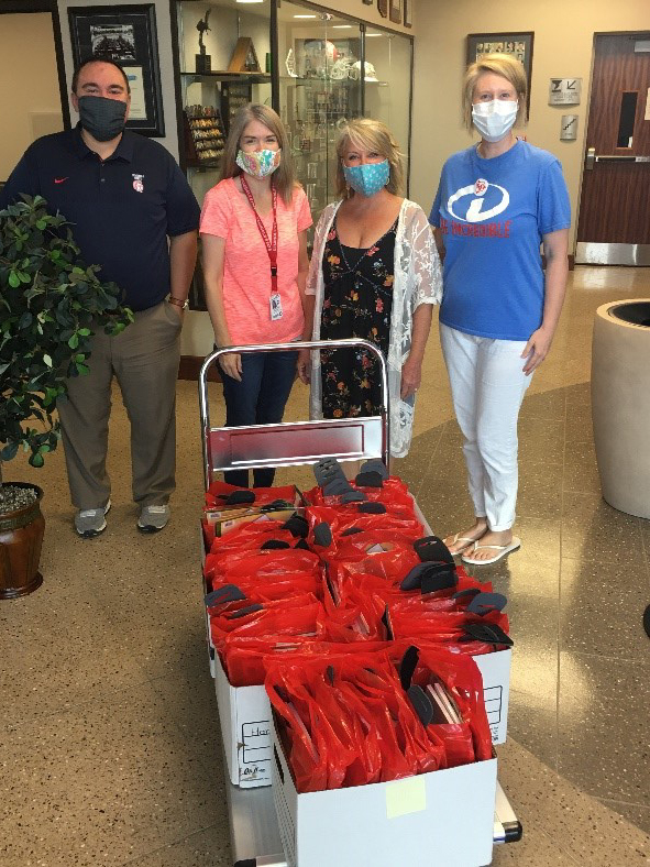 Four people in mask with bags.