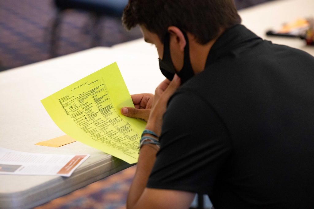 Male student looking a paper. 