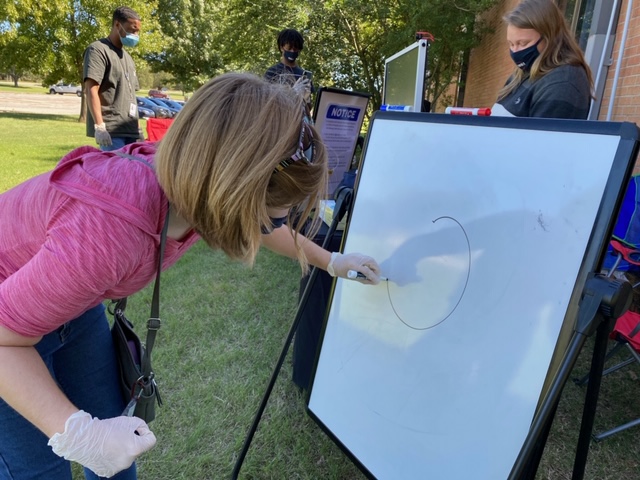 Student draws at Pictionary event.