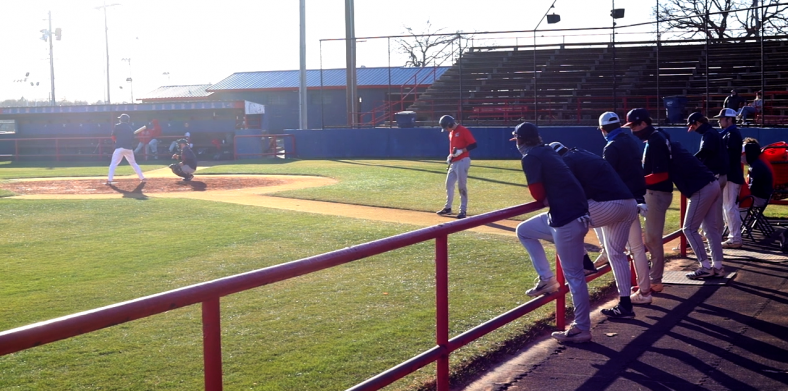 Seminole State College Baseball player stand at the dugout during practice