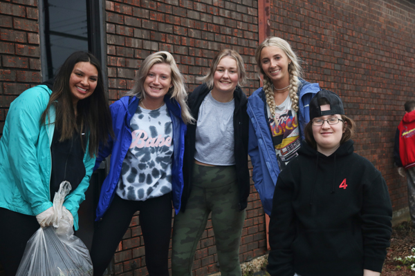 SSC and ECU students worked to clear cigarette butts and trash from the front of Mama T’s property as part of a collaborative community service project for their Composition II course.