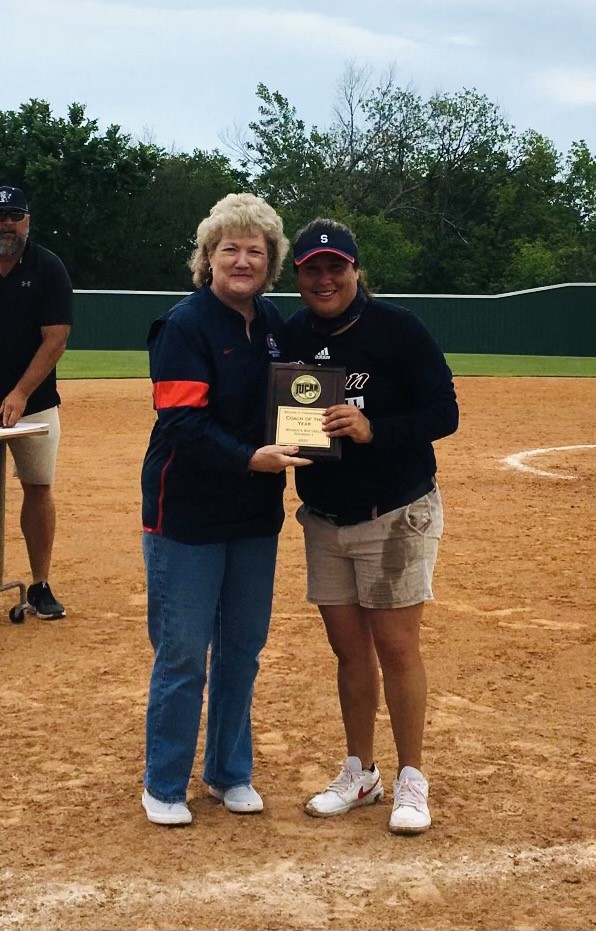 SSC President Lana Reynolds congratulates SSC Softball Head Coach Amber Flores after she is named NJCAA Region II Coach of the Year at the regional tournament in Muskogee on May 16.