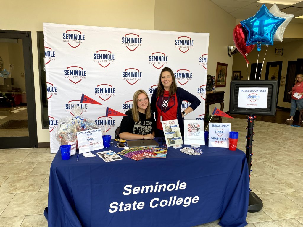 Seminole State College sophomore Jenna Harrison (left), of Tecumseh, and Recruitment Specialist Britney Honsinger (right) greet perspective students during the College’s Reach Higher Reconnect Week. 
