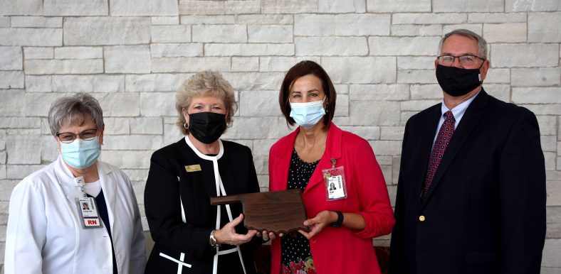 Pictured (left to right): St. Anthony Hospital – Shawnee Registered Nurse Linda Brown, SSC President Lana Reynolds, St. Anthony Hospital – Shawnee President Angi Mohr and SSC Director of the Rural Business and Resources Center Danny Morgan pose with a Business Partnership Excellence Award from the Oklahoma State Regents for Higher Education.