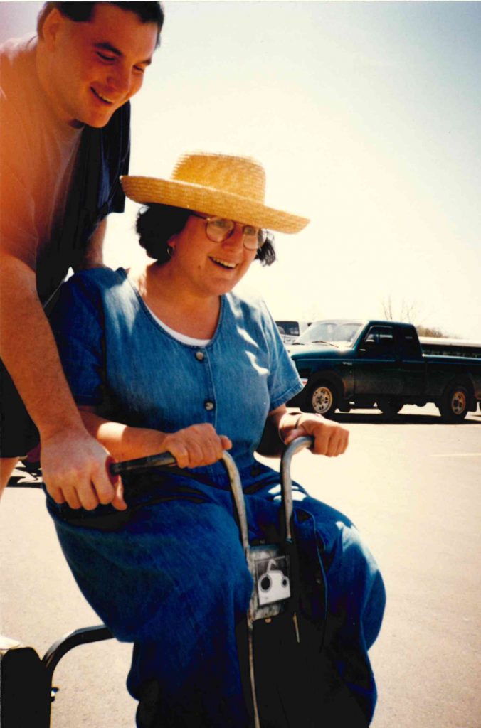 Former speech instructor Marie Dawson races to the finish line during the tricycle races.