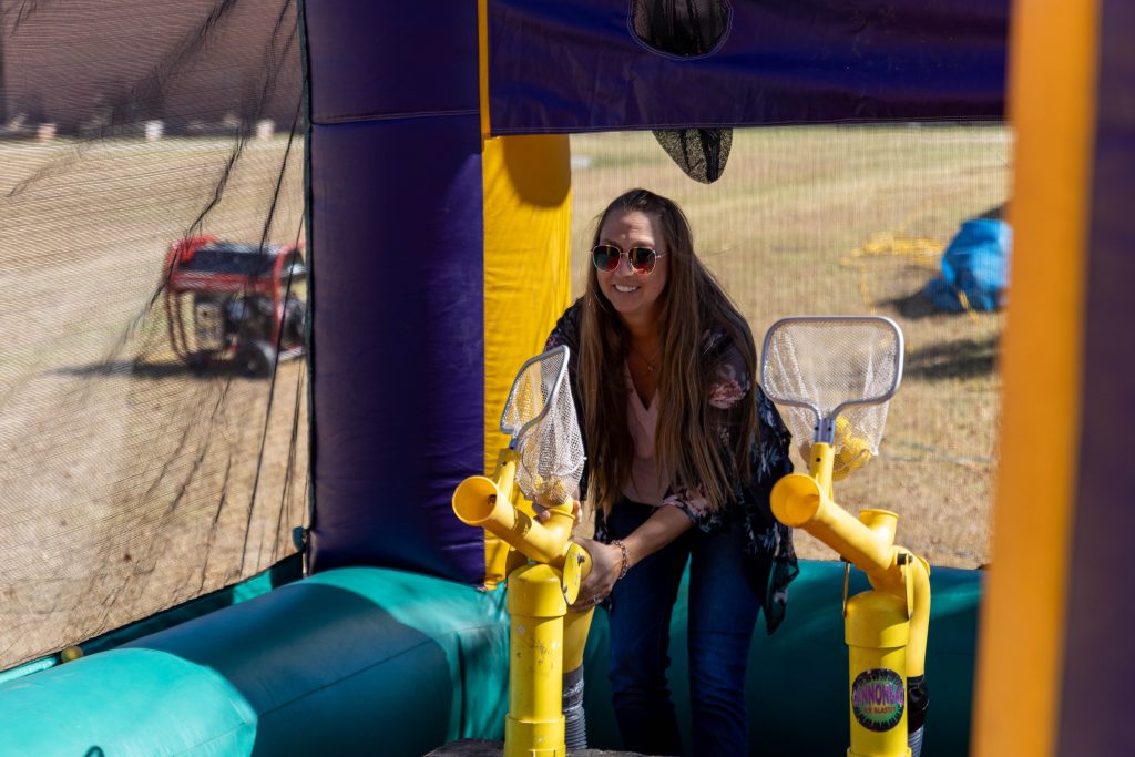 Melinda Sims, Director of Residential Life and Student Activities, joins in on the games at the Fair Day event. Here she is seen playing one of the many fair games set up in the courtyard on campus.