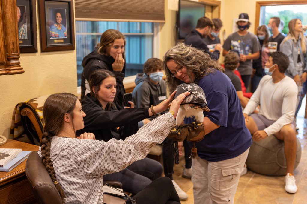 Bree Dunham, assistant manager of the CPN Aviary, shows PLC members an augur buzzard, a bird native to Africa.