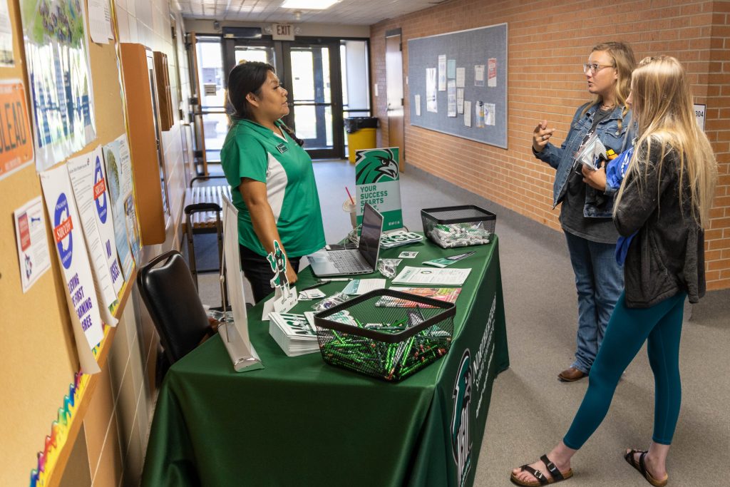 Patsy Spottedbird (left), a representative from Northeastern State University discusses the transfer process with Sierra Josselyn (center), of Seminole, and Ashlyn Tait (right), of Chanute, Kansas.