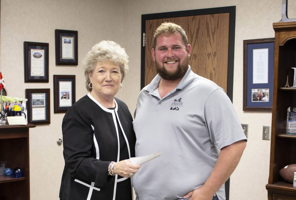 Seminole State College President Lana Reynolds (left) thanks Brandon Streater (right), owner of Streater Construction, for a donation to the SSC Educational Foundation