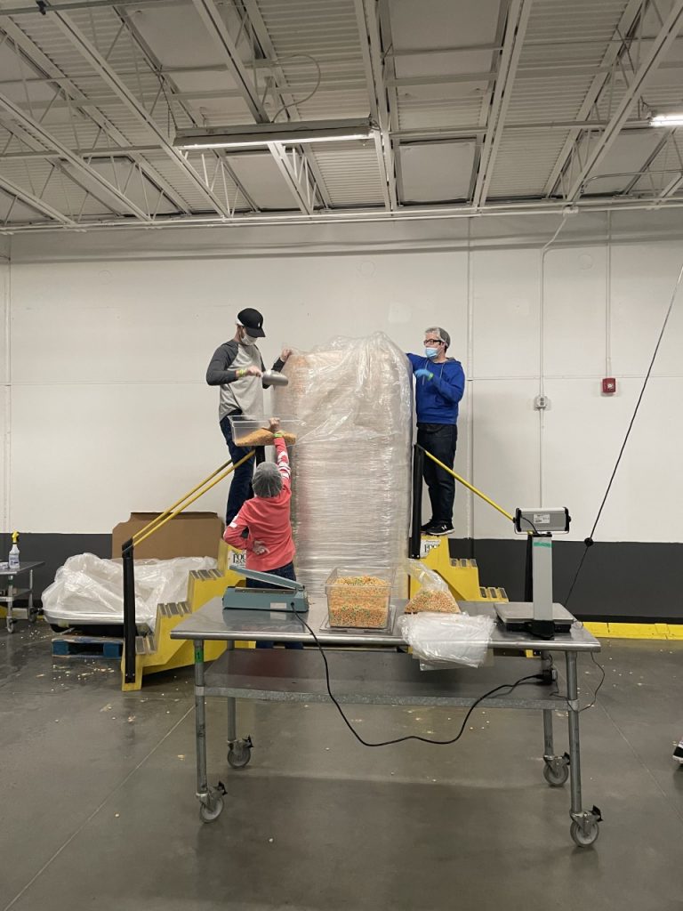 PLC students Colin Frederick (left), of Seminole, and Thomas Choate (right), also of Seminole, unload breakfast cereal at the Regional Food Bank.