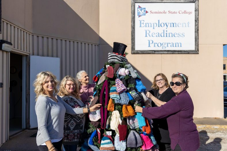 Pictured (left to right): Workforce staffer Danita Williams, SSC Employee Readiness Assistant Job Skills Specialist Christina Parsons, SSC Vice President for Academic Affairs Dr. Linda Goeller, SSC Director of Employment Readiness Veronica Taylor and Workforce staffer Scarlet Figueroa pose with the Happy Holiday Tree, decorated with winter clothing items available to those in need