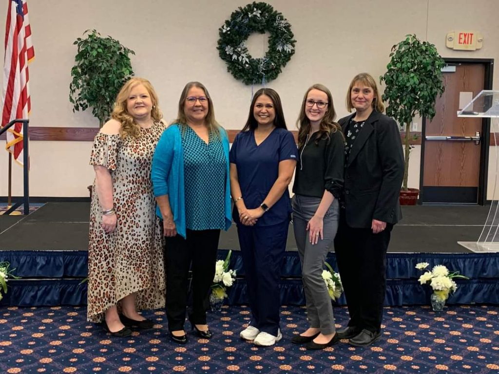 Pictured (left to right): Nursing Program Director Crystal Bray, Assistant Professor Cynthia Tainpeah, nursing graduate Michelle Mayfield, Assistant Professor Damalia Lester and Assistant Professor Sheryl Denton pose during SSC Nursing's pinning ceremony.
