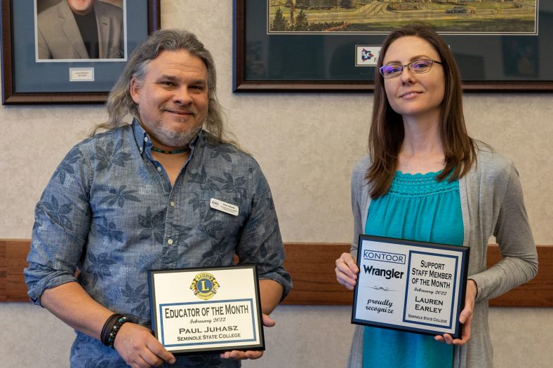 Faculty Member of the Month Paul Juhasz and Staff Member of the Month Lauren Earley pose with their plaques at the Seminole Chamber of Commerce Forum Feb. 10.