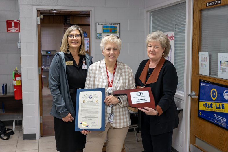 Gordon Cooper Technology Center Superintendent Julie McCormick (left) and Seminole State College President Lana Reynolds (right) congratulate MLT Program Director Kelly Hankal (center) on her Outstanding Instructor award.