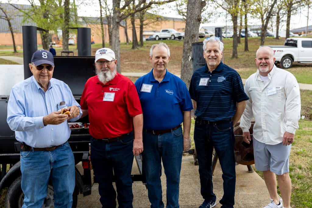 Members of the Seminole State College Educational Foundation Board of Trustees pose in front of the grill where they cooked hot dogs, brats and hot links for SSC faculty and staff Friday at an Employee Appreciation Earth Day Cookout. Trustees (pictured left to right) Jim Hardin, David Wilson, Chris Moore, Mark Schell and Lance Wortham grilled at the campus’ Roesler Park while employees ate and visited under the Smart Pavilion. Over 90 employees participated in the event.