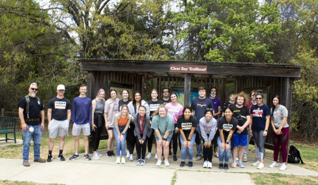 Seminole State College President’s Leadership Class students and Forester Riley Coy of the Oklahoma Forestry Services paused to take a photo before heading out on a 1.5-mile hike at Lake Thunderbird on April 21. Forester Coy provided insight about trees and other flora in the area, as well as the state. Pictured (left to right, back row): Riley Coy, Blake Parrick, Kaden Brill, Jenna Harrison, Anna Kelsey, Sydney Winchester, Uriah McPerryman, Abigail Shook, Thomas Choate, Marlee Hunter, Colin Dulaney, Jordan Lewis, Hunter Winn, Frank Bourlon, Brent White, Hailey Wallace, and Ayzia Shirey; (left to right, front row): Erin Bronson, Allyson Randall, Ava Adams, Caryssa Bui, Rebekah Choate, Cynthia Bui.