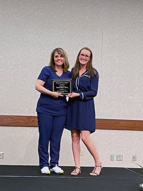 Assistant Professor of Nursing Damaila Lester (right) presents the Excellence in Nursing Award to SSC nursing graduate Rondell Johnson-Bennet.