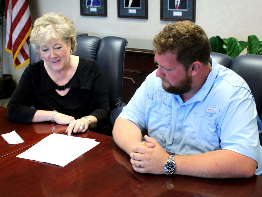 Seminole State College President Lana Reynolds (left) visits with Seminole businessman and real estate developer Brandon Streater (right) about the President’s Leadership Class program at the College.
