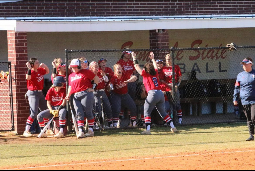 Softball team cheers from dugout