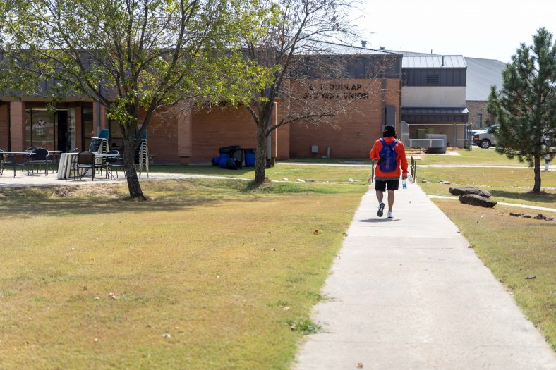 A Seminole State College student is shown walking between classes on campus.