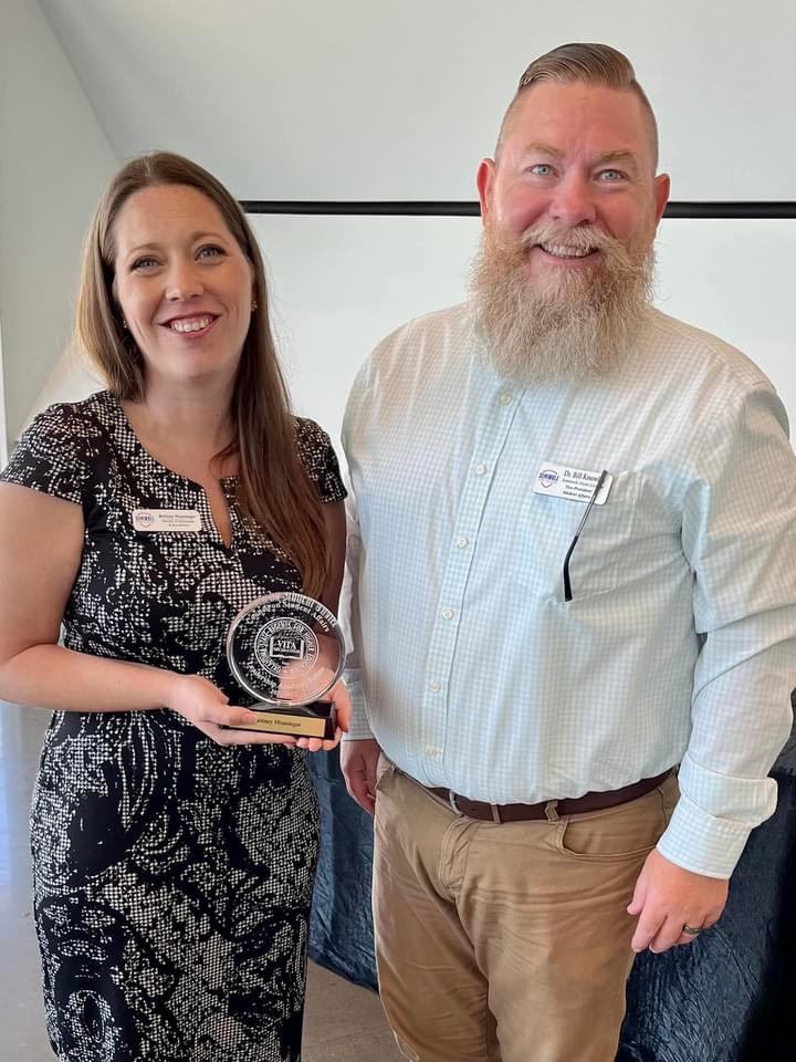 SSC Vice President for Academic Affairs Dr. Bill Knowles (right) congratulates Director of Advisement and Recruitment Britney Honsinger after she is recognized for completing the Council on Student Affairs Leadership Academy on July 7.