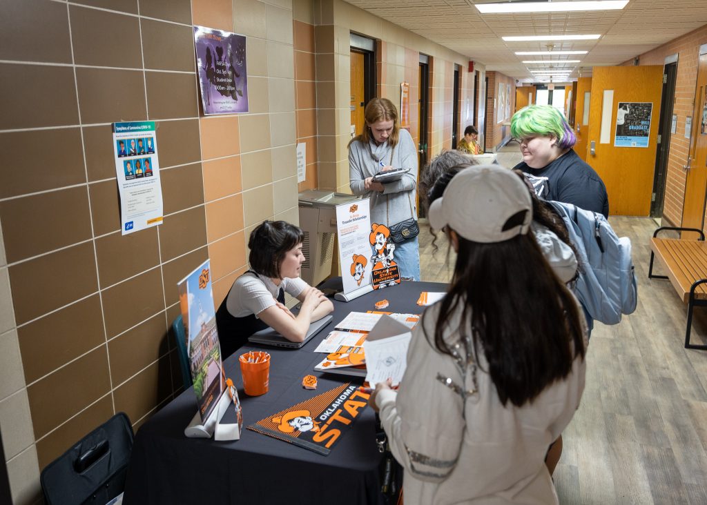 Students speak with a representative from Oklahoma State University during the Seminole State College Transfer Fair on Oct. 5.