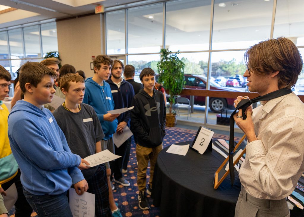 SSC business student Brent White teaches a lesson about how to tie a full Windsor necktie knot.