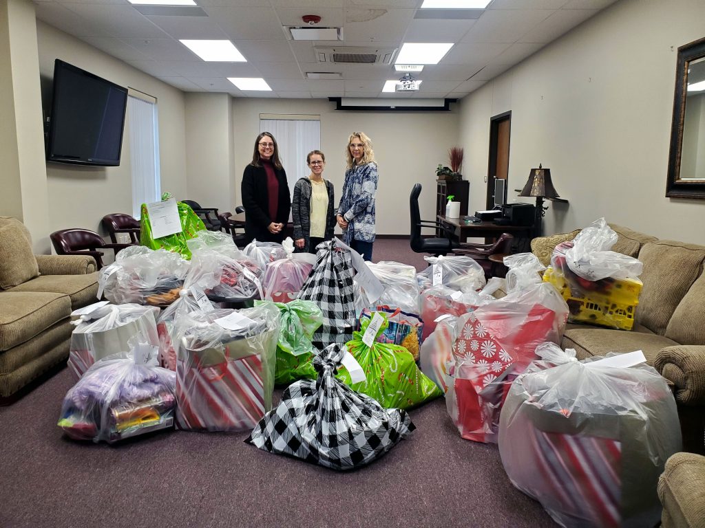 Testing Coordinator Lauren Early, President’s Office Manager Tisha Simon and Student Affairs Administrative Assistant Toni Wittman prepare the gifts to be delivered.