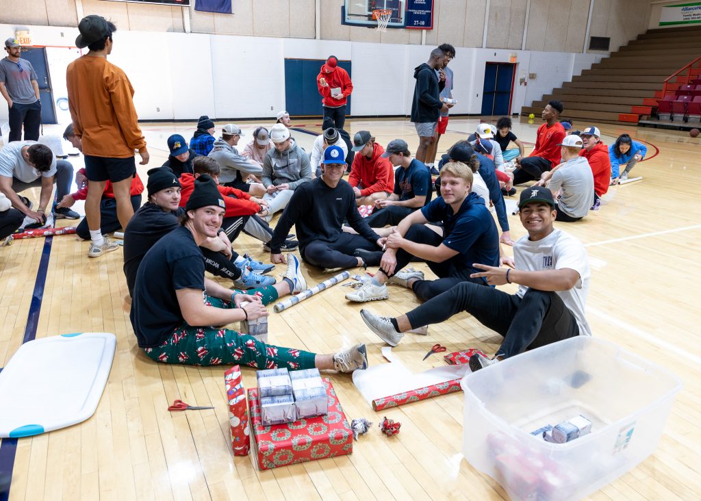 Seminole State College Athletes are shown wrapping gifts for the annual Earl Knowles free community Christmas dinner, organized by the Seminole Rotary Club.