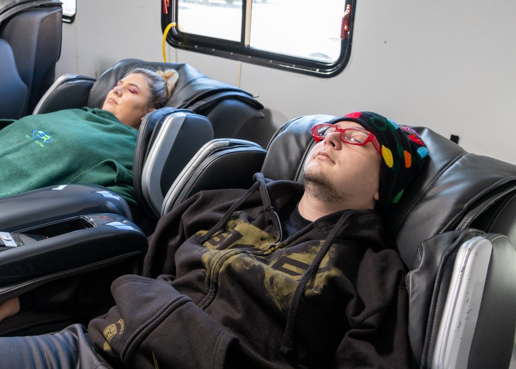 Students are shown decompressing before finals week in the free massage chairs. This is just one of many activities provided to students during De-Stressor Week.