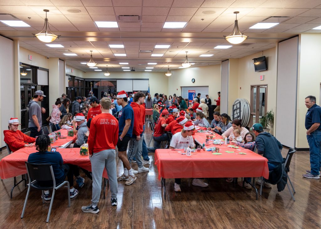 Seminole State College Athletes, Coaches, Faculty and Staff assist community children with arts and crafts projects at the SSC annual Night at the Lights event on Dec. 5 at Magnolia Park in Seminole.