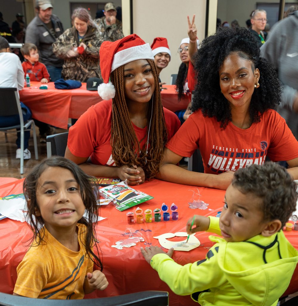 SSC volleyball players Cortlyn Bennett, of Waxahachie, Texas, and O’Briona Wilkins, of Oklahoma City, help a group of kids create some holiday crafts.