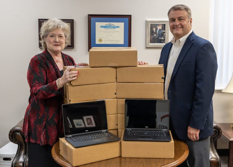 SSC President Lana Reynolds (left) thanks State Farm Agent Darren Frederick (right) for the company’s donation of 25 laptops to the College’s laptop loan program.