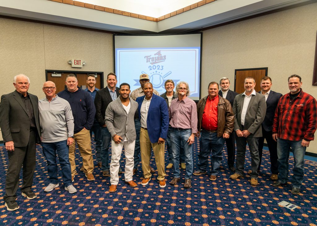 Trojan alumni and coaches pose for a photo following the event.