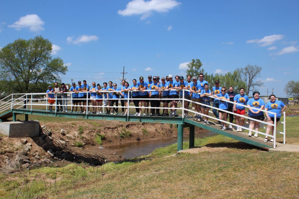 Seminole State College President’s Leadership Class members pose for a group photo before cleaning up the Seminole Municipal Park, alongside Magnolia Creek.