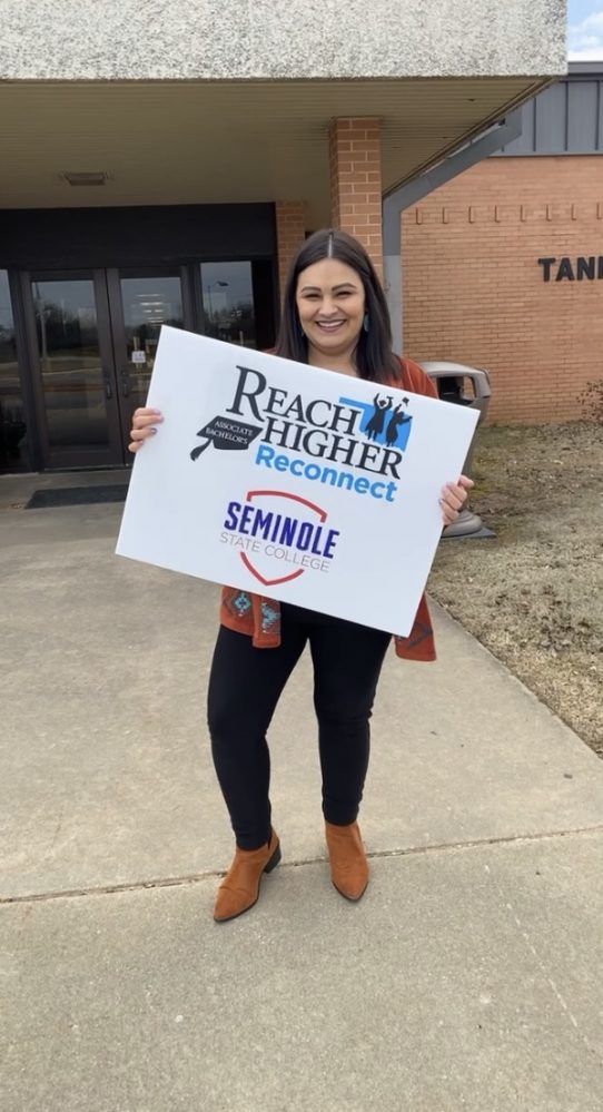SSC Online Degree Office Coordinator Laura Votaw stands outside of Tanner Hall, where prospective students are invited to attend the Reach Higher: Reconnect event on April 11 and 12