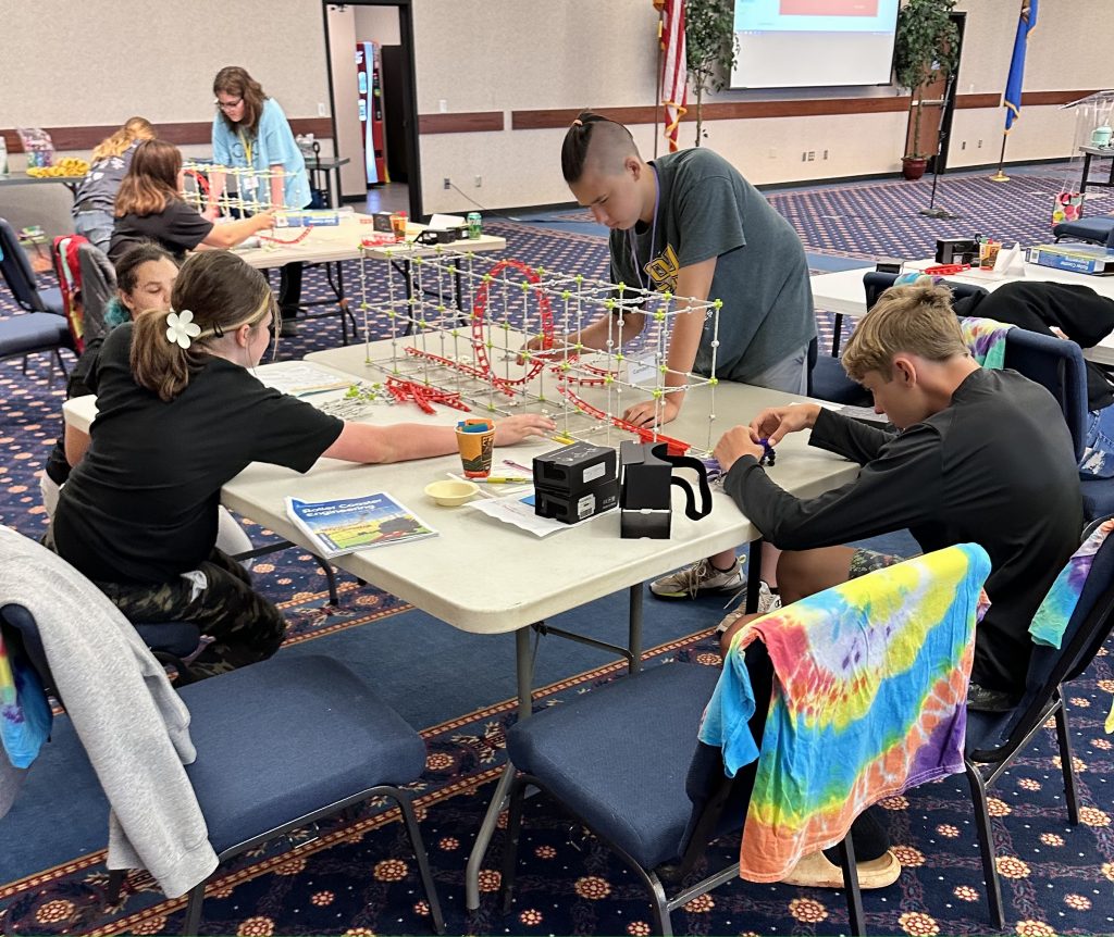 Eighth-grade students participating in the Seminole State College Talent Search/FOCUS federal grant programs Coaster Camp are pictured working together, problem solving and building their own rollercoasters.