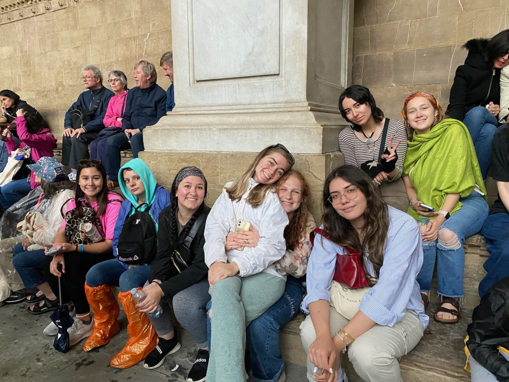 SSC Students pose for a photo on the steps outside of the Accademia Gallery in Florence.