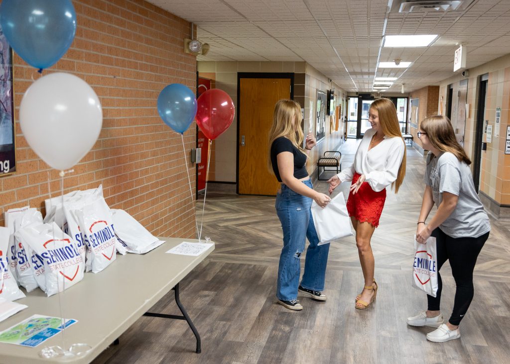 Pictured: Assistant Professor of Agriculture Wendy Rich (center) welcomes two students in Tanner Hall.